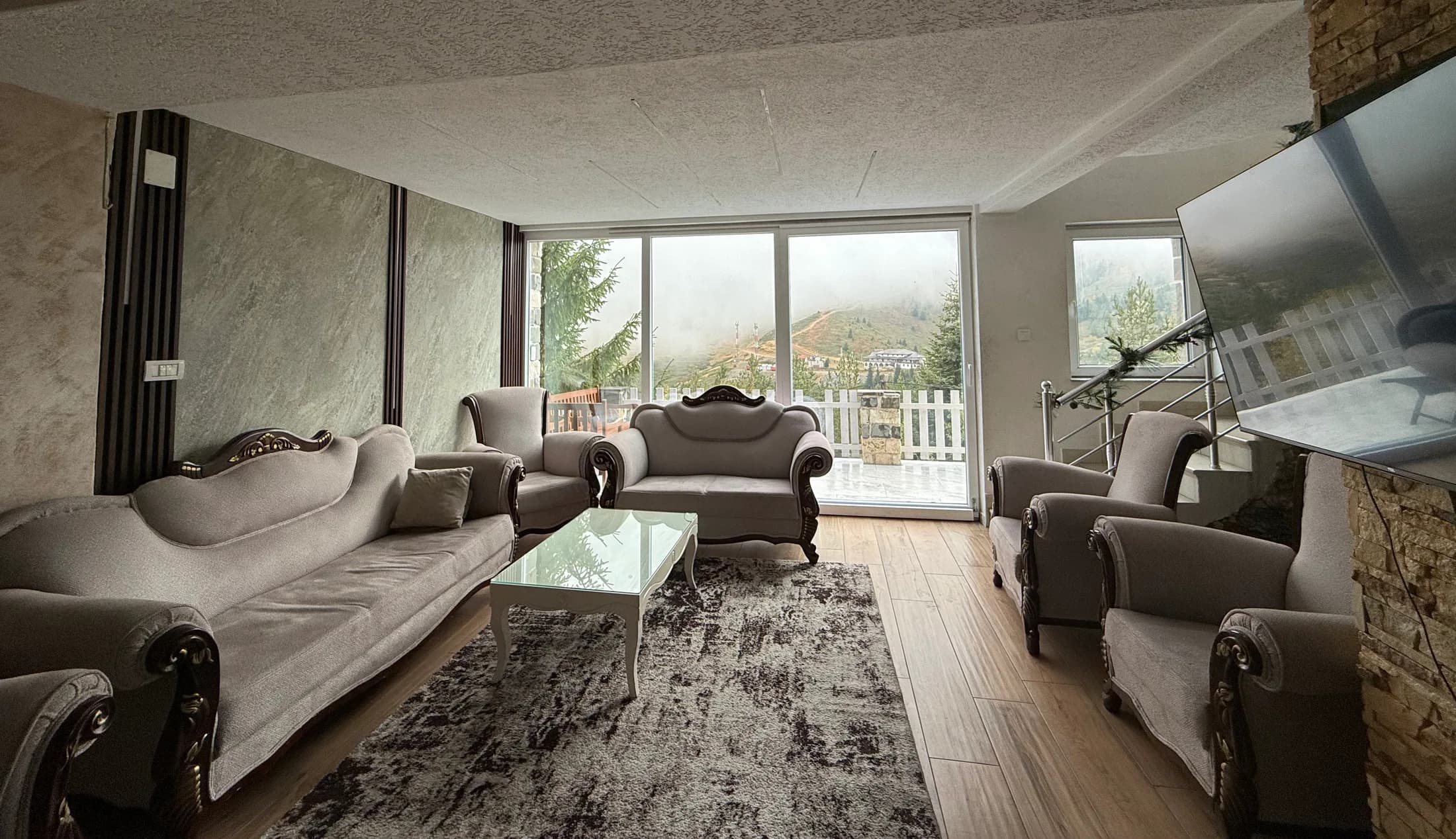 The lounge at Villa Noar II, with a mountain view through the windows