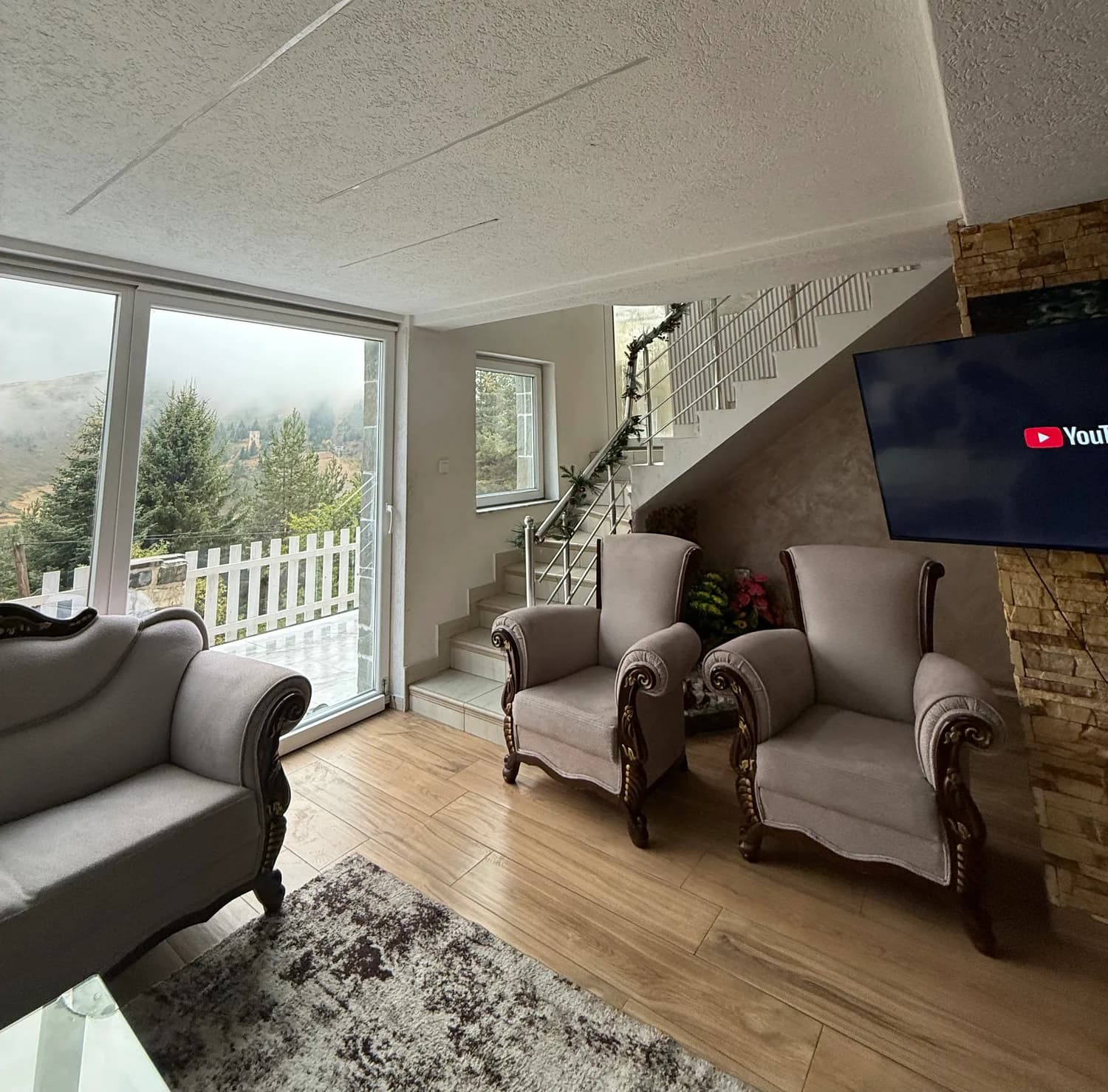 The sitting room and stone fireplace at Villa Noar II